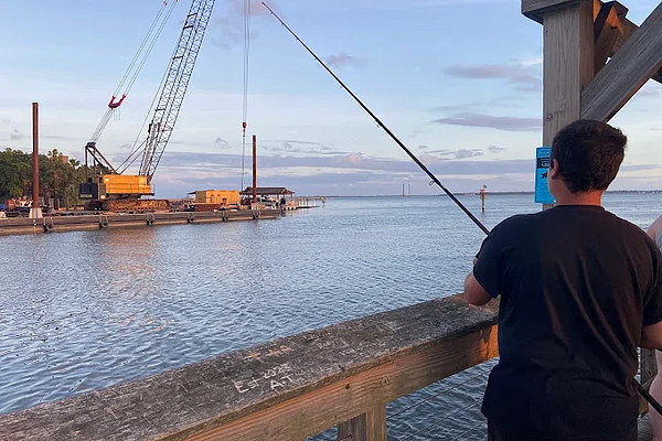 A man fishing relies on fishing rod and reel rental Charleston provided by Charleston Fishing Rentals in Isle of Palms, South Carolina.