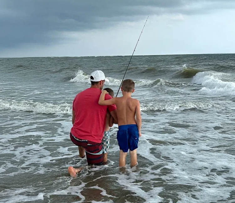 Two people fish in the ocean as Charleston Fishing Rentals provides fishing gear rentals Charleston SC in Isle of Palms, South Carolina.