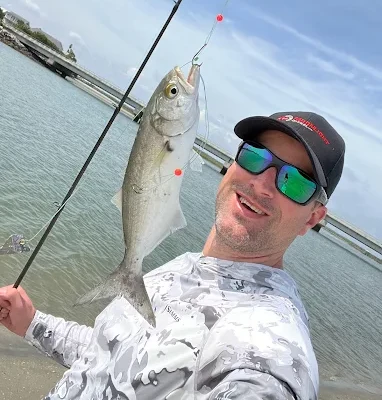 A beach catch is held up using fishing tackle rental Charleston SC from Charleston Fishing Rentals.