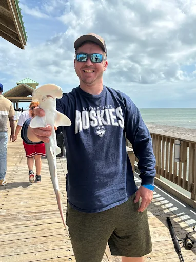 A beach catch is held up using fishing tackle rental Charleston SC from Charleston Fishing Rentals in Isle of Palms, South Carolina.