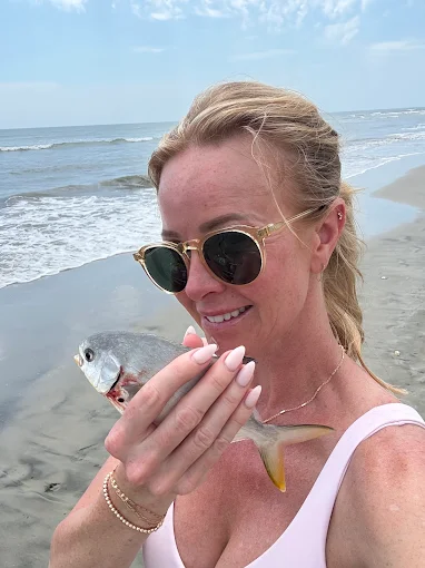 A woman on the beach enjoys time near services like beach fishing equipment rental Charleston from Charleston Fishing Rentals.